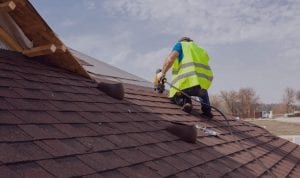 Man on a San Antonio roofinh system performing repair | WeatherTech Roofing San Antonio Roofer Contractor Company Residential and Commercial