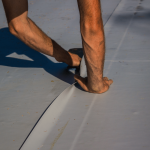 A flat roof being worked on by San Antonio roofing company WeatherTech Roofing