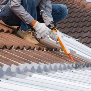 Picture showing a member of the team working on repairing a roof leak