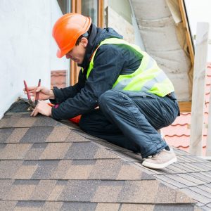 Picture of a roof leak repair being fixed by a WeatherTech employee