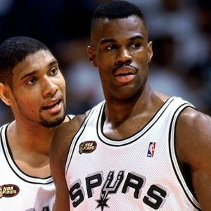 The Alt text could be: "San Antonio Spurs legends David Robinson and Tim Duncan in action on the court, symbolizing the strength and durability of slate and metal roofing as discussed in the blog post.