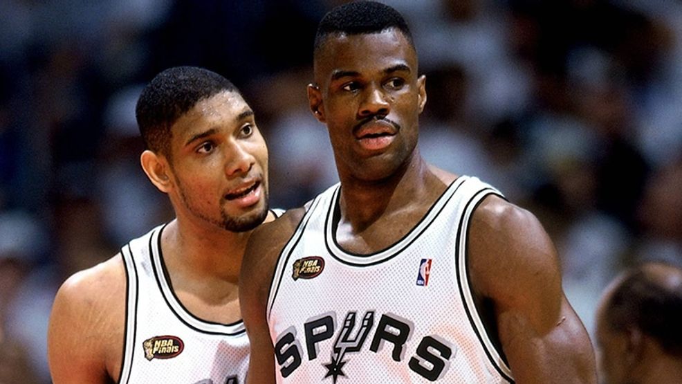 The Alt text could be: "San Antonio Spurs legends David Robinson and Tim Duncan in action on the court, symbolizing the strength and durability of slate and metal roofing as discussed in the blog post.